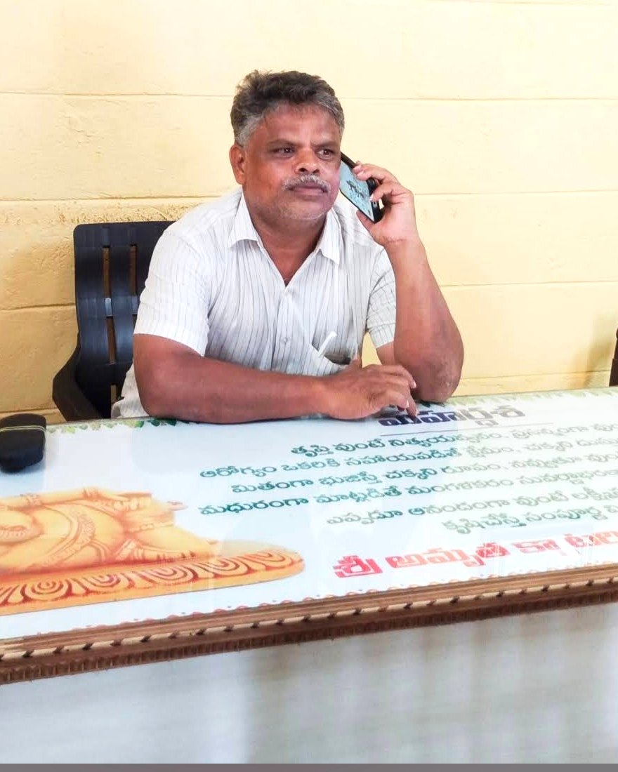 Founder of Sri Amrutha Catering & Events taking a booking enquiry over the phone at the Tirupati office